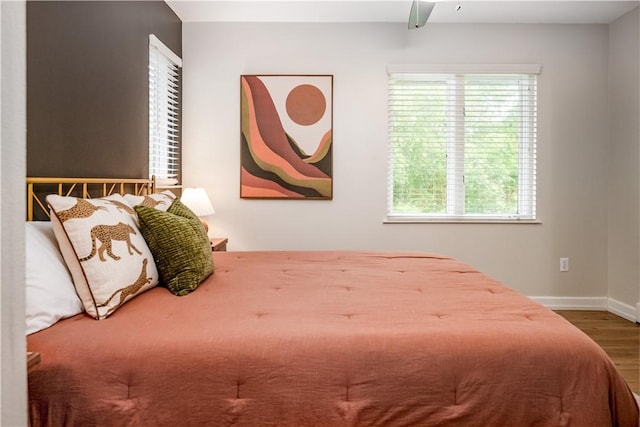 bedroom with wood-type flooring and ceiling fan