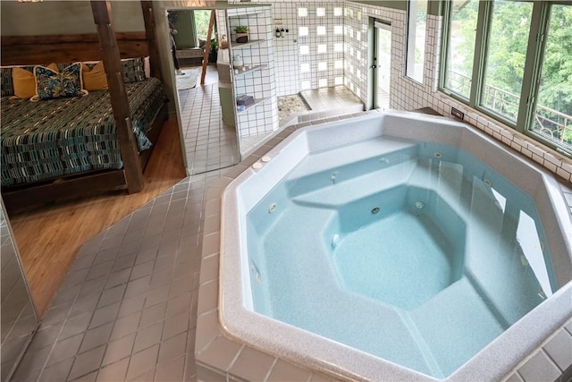 view of swimming pool featuring an indoor hot tub