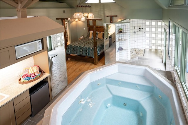 interior space featuring hardwood / wood-style flooring, plenty of natural light, and a tub