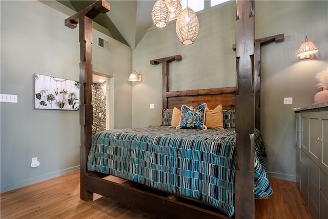 bedroom featuring hardwood / wood-style floors and lofted ceiling