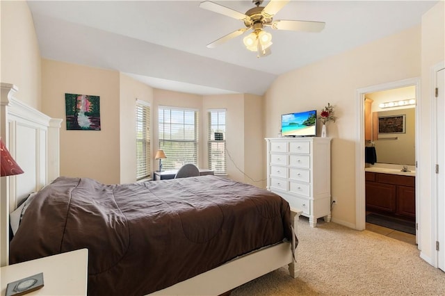 305 Holleman Dr E Unit 202, College Station, TX 77840 - bedroom with connected bathroom, ceiling fan, a sink, vaulted ceiling, and light colored carpet