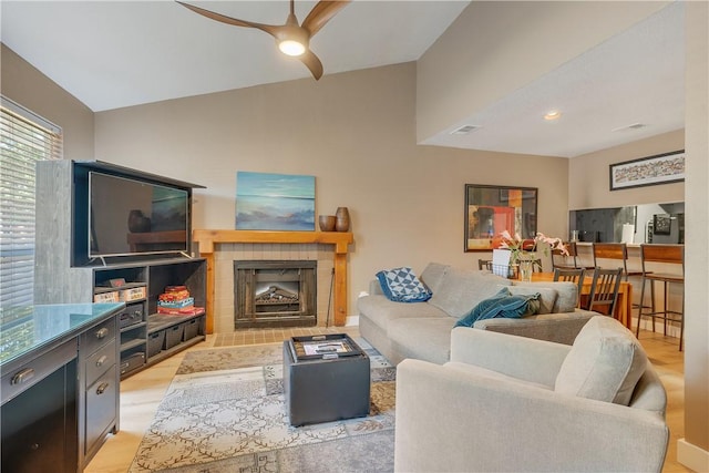 1501 Stallings Dr Unit 54, College Station, TX 77840 - living area featuring lofted ceiling, light wood finished floors, ceiling fan, visible vents, and a fireplace