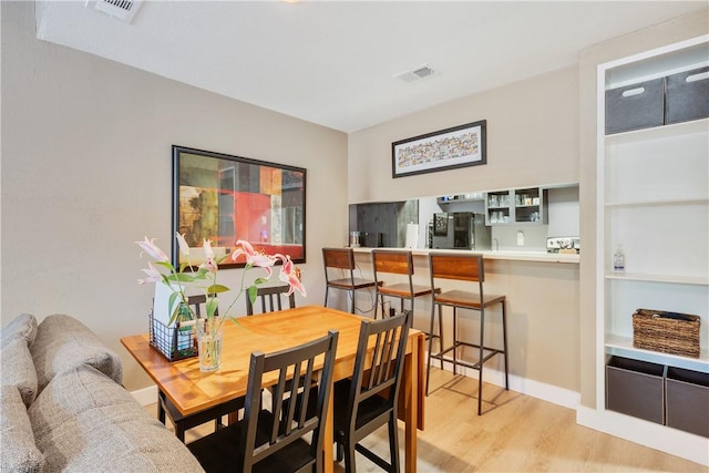 1501 Stallings Dr Unit 54, College Station, TX 77840 - dining space featuring baseboards, light wood finished floors, and visible vents