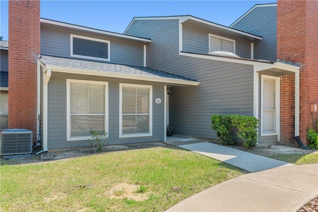 1501 Stallings Dr Unit 54, College Station, TX 77840 - view of front of house featuring cooling unit and a front lawn