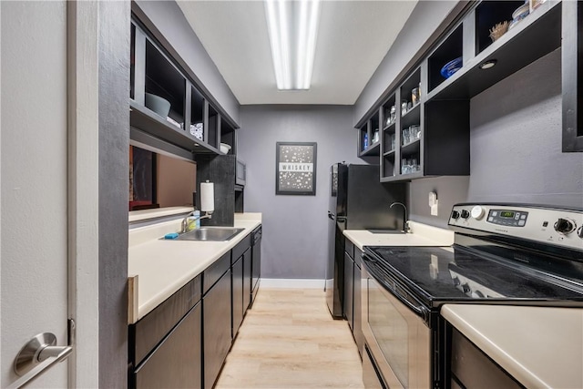 1501 Stallings Dr Unit 54, College Station, TX 77840 - kitchen with light wood finished floors, a sink, open shelves, black appliances, and light countertops