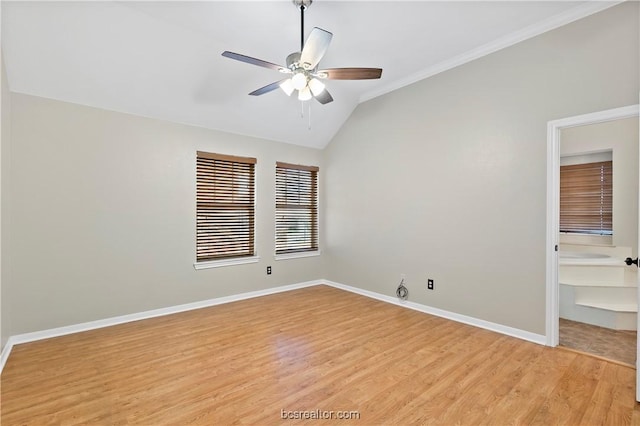 spare room featuring light wood-type flooring, vaulted ceiling, ceiling fan, and ornamental molding