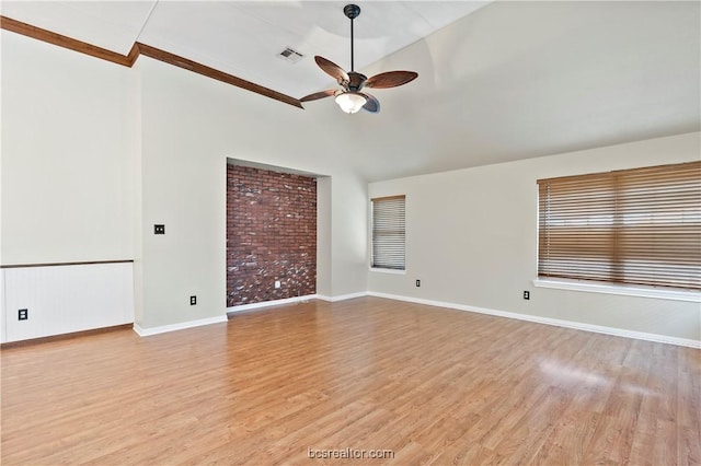 empty room featuring light wood-type flooring, vaulted ceiling, and ceiling fan