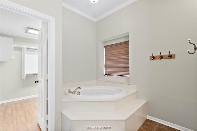 bathroom featuring a washtub, wood-type flooring, and crown molding