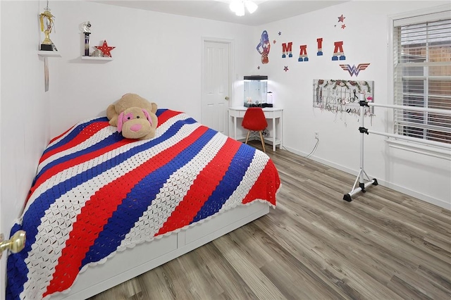 bedroom with hardwood / wood-style flooring