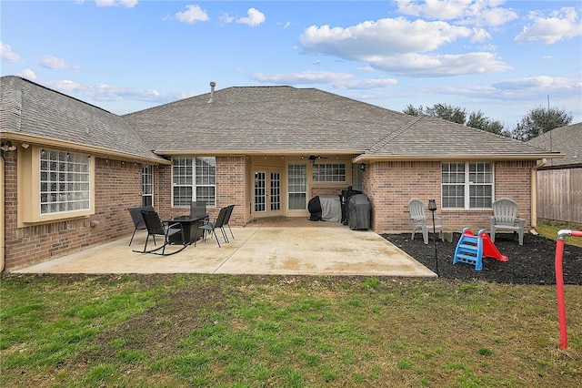 rear view of property featuring a patio, ceiling fan, and a yard