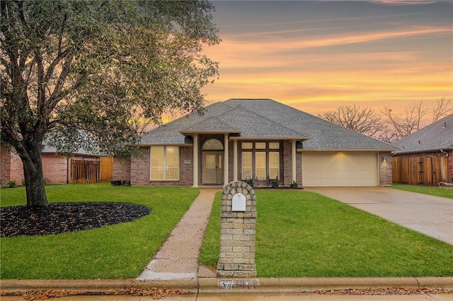 prairie-style home with a yard and a garage