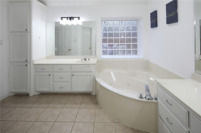 bathroom featuring tile patterned flooring, vanity, and a tub to relax in