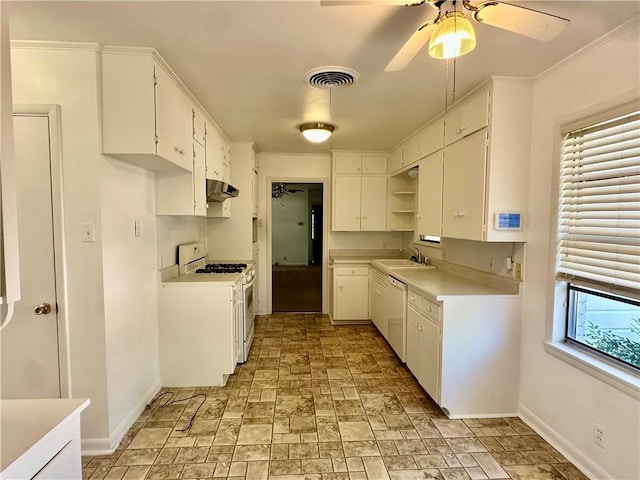 kitchen featuring a wealth of natural light, white cabinetry, sink, and white appliances