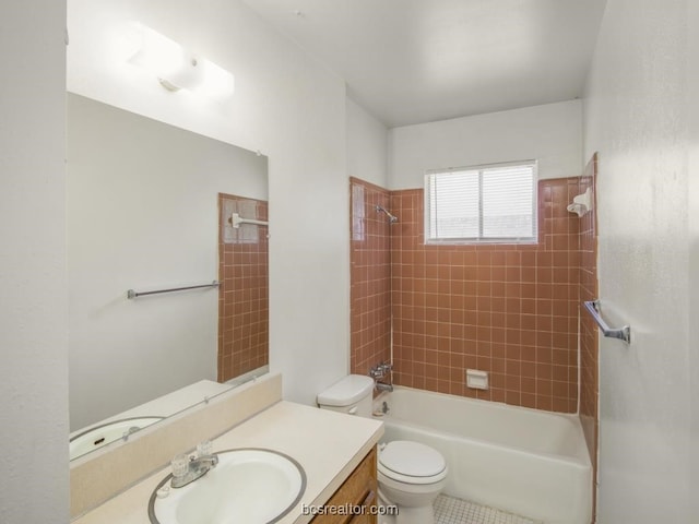 full bathroom with vanity, tiled shower / bath combo, and toilet