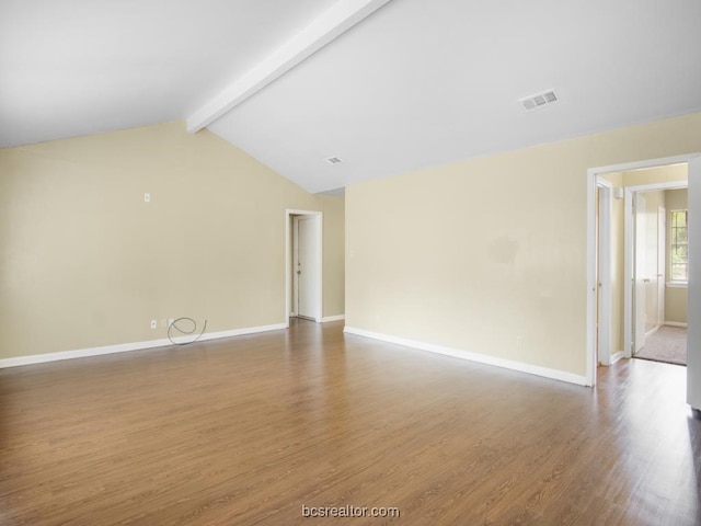 spare room featuring vaulted ceiling with beams and dark hardwood / wood-style flooring