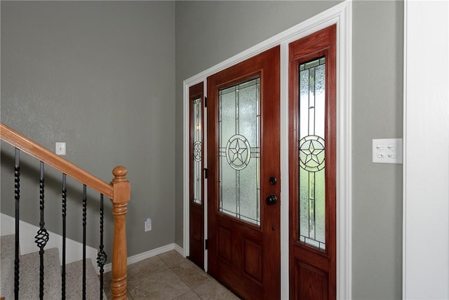 entryway with stairway and baseboards