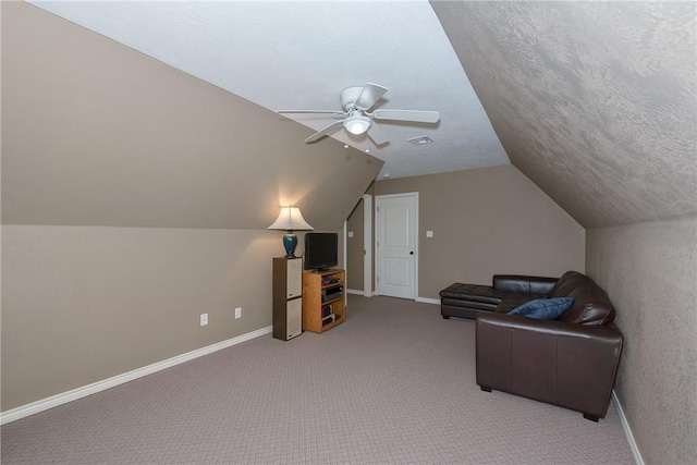sitting room with vaulted ceiling, baseboards, carpet, and a ceiling fan