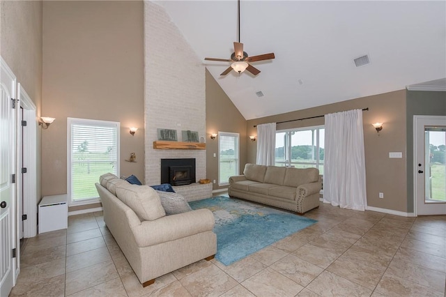 living area featuring baseboards, visible vents, a ceiling fan, a fireplace, and high vaulted ceiling
