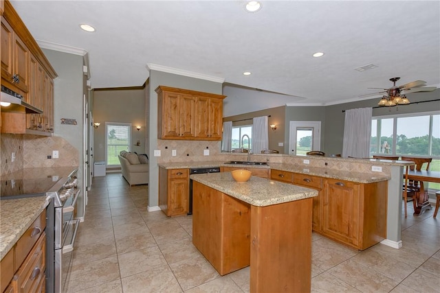 kitchen with a sink, a center island, range with two ovens, a peninsula, and tasteful backsplash