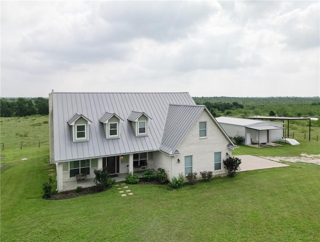 cape cod home with a standing seam roof, a porch, a front yard, and metal roof