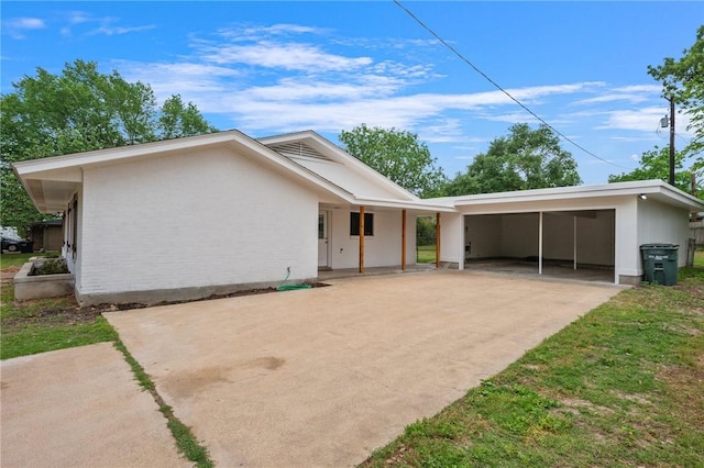 single story home with driveway and an attached carport