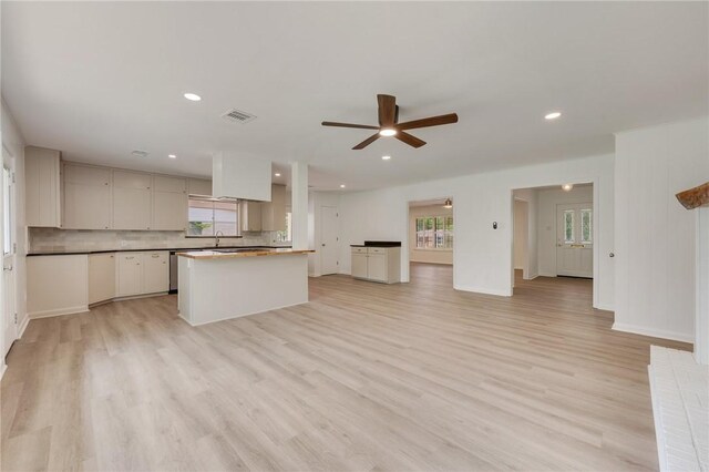 kitchen featuring light wood finished floors, visible vents, and a healthy amount of sunlight