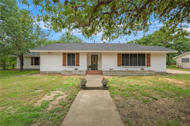 single story home featuring stucco siding and a front yard