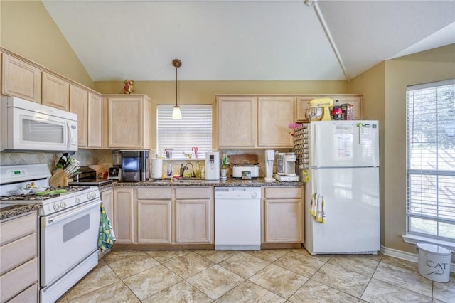 kitchen featuring white appliances, light brown cabinets, lofted ceiling, a sink, and tasteful backsplash