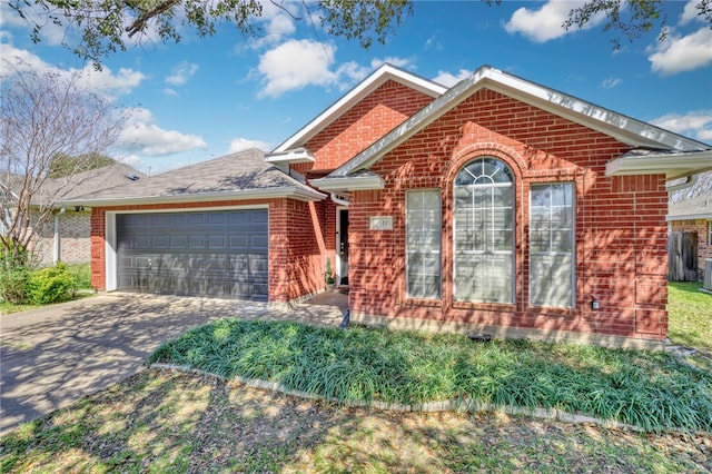 view of front of home with brick siding, driveway, and an attached garage