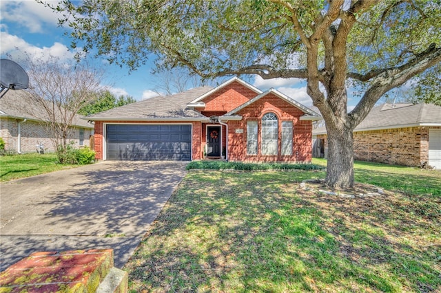 single story home with a garage, a front lawn, brick siding, and driveway