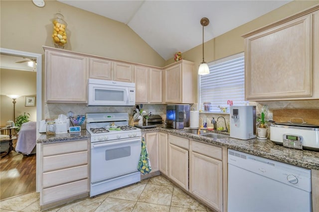 kitchen featuring light brown cabinetry, backsplash, white appliances, and a sink