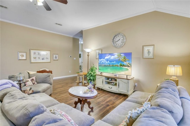 living area featuring visible vents, lofted ceiling, ornamental molding, and dark wood finished floors