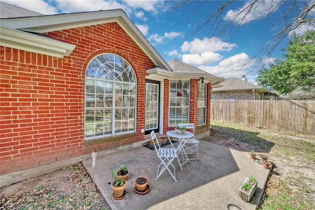 view of patio / terrace featuring fence