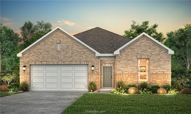 view of front of property with a lawn and a garage