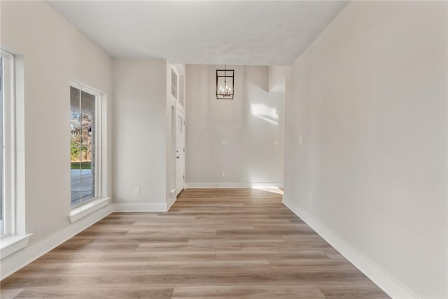 interior space featuring light hardwood / wood-style flooring and a notable chandelier