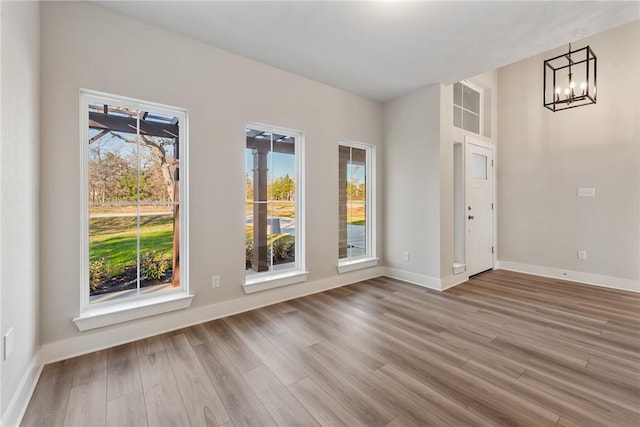 interior space featuring hardwood / wood-style flooring and a chandelier