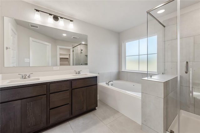 bathroom with plus walk in shower, vanity, and tile patterned floors