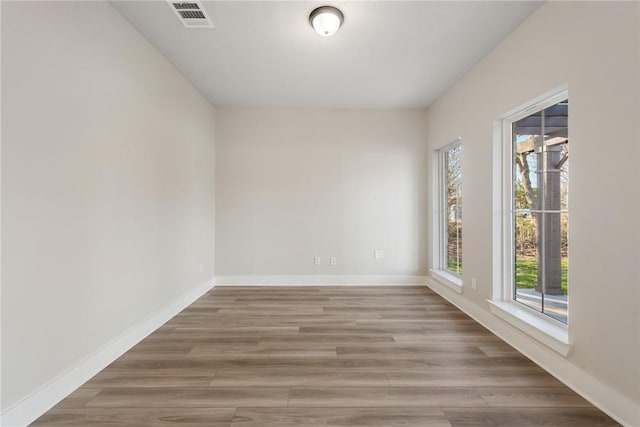 spare room with wood-type flooring