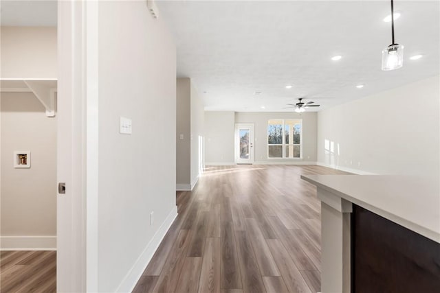 unfurnished living room featuring hardwood / wood-style flooring and ceiling fan