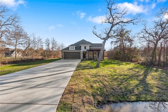 view of front of house featuring a front yard and a garage