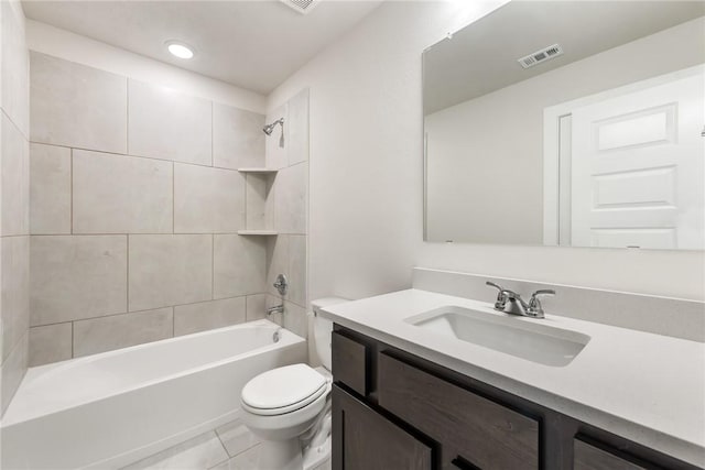 full bathroom with toilet, tile patterned flooring, vanity, and tiled shower / bath