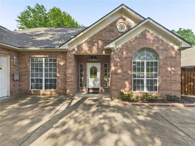 5614 Thomas Nelson Dr, Tyler, TX 75707 - property entrance featuring brick siding and roof with shingles