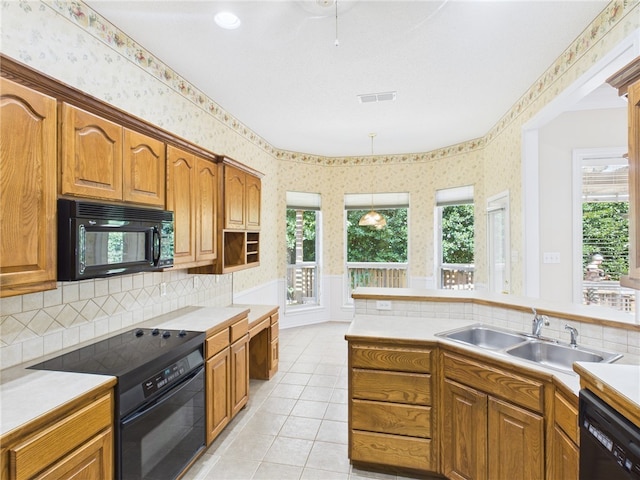 5614 Thomas Nelson Dr, Tyler, TX 75707 - kitchen featuring black appliances, wallpapered walls, brown cabinets, and wainscoting