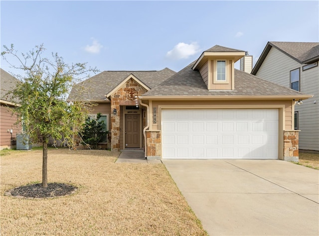 view of front of house with stone siding, driveway, an attached garage, and a shingled roof