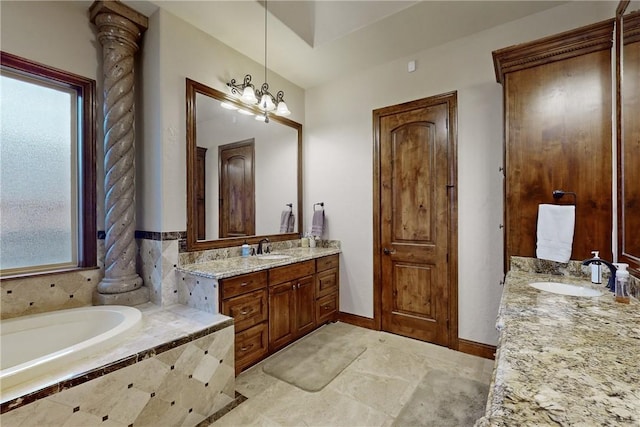 full bath featuring a garden tub, two vanities, baseboards, and a sink