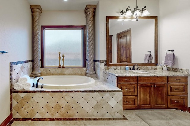 bathroom featuring tile patterned floors, vanity, and a garden tub