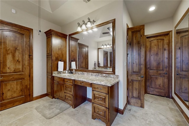 bathroom featuring visible vents, baseboards, and vanity