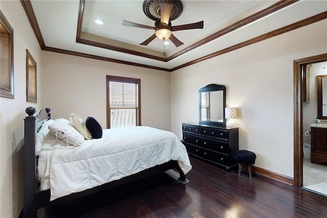 bedroom with a ceiling fan, wood finished floors, baseboards, a tray ceiling, and crown molding