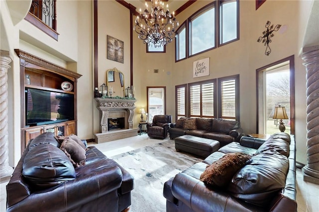 living room featuring a high end fireplace, decorative columns, a wealth of natural light, and a chandelier