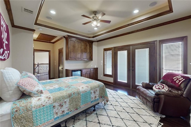 bedroom featuring a tray ceiling, access to exterior, visible vents, and ornamental molding